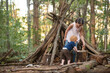 © Cavan Images - Brother and sister building a fort in the Woods