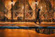 © Cavan Images - Young man walking on illuminated city street at night during winter