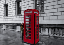 Young Girl Next To A Telephone Booth In London