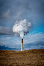 Power Plant Smokestack Releasing Pollution And Steam