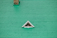 A Green Roof With A Triangular Window