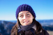 © Cavan Images - Closep up portrait of a smiling woman with blue hat in a sunny day