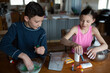© Cavan Images - Kids making homemade slime together at home
