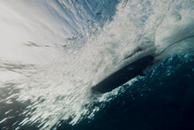 Low Angle View Of Man Surfing Underwater In Sea