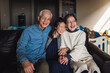 © Cavan Images - Portrait of adult daughter and her senior parents laughing
