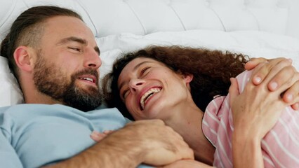 Canvas Print - Funny couple talking, communication in bed and comic conversation in bedroom together in morning, hug during discussion and happy with love in house. Man and woman laughing at comedy joke in home