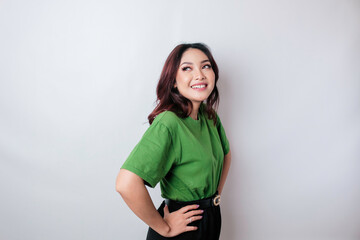 Wall Mural - A portrait of a happy Asian woman is smiling wearing green t-shirt isolated by a white background