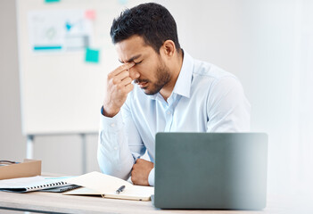 Tired, headache and eye strain from laptop with businessman while writing in notebook in corporate company. Stress, burnout and fatigue with young professional male at desk in office building