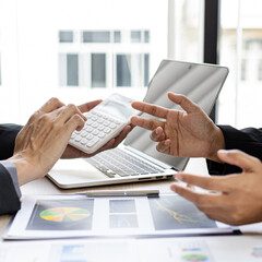 Wall Mural - Meeting a team of businessmen, Executives and accountants meeting about the company's revenue graph in the office with laptops and calculators, Finance concept.