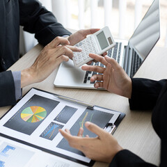 Wall Mural - Meeting a team of businessmen, Executives and accountants meeting about the company's revenue graph in the office with laptops and calculators, Finance concept.