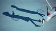 © David L/peopleimages.com - Tennis, sports and people on court in sunshine with silhouette or shadow and mockup. Active fitness woman, man or professional sport player with racket from above or top in summer with ground mock up