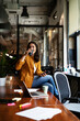 © JustLife - Young businesswoman drinking coffee in her office. Woman enjoy in coffee break..