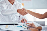 Fototapeta Nowy Jork - Businessman shaking hands with his partner to make a corporate deal at meeting in the office. Zoom of professional employees b2b welcome with handshake at company conference, workshop or convention