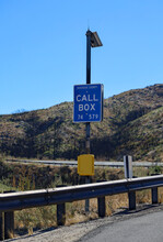 A Call Box With Blue Call Box Sign On The Side Of The Highway.