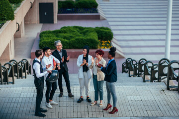 Wall Mural - Urban businesspeople applauding in street