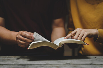 Christian couple or group reading study the bible together and pray at a home or Sunday school at church. concept studying the word of god.