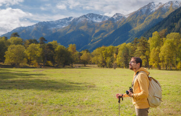 Wall Mural - trip to Caucasus mountains, Arkhyz, Teberdinsky reserve. concept of discovery and exploration of wild places in early autumn. Man hiking in mountains with backpack and photo camera