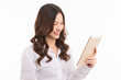 © Chaiwat - Asian woman long hair wearing a white shirt professional operating her tablet pc. isolated on white background.