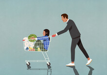 Father Pushing Daughter And Groceries In Shopping Cart
