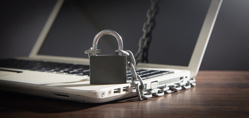 Laptop locked with chains and padlock.