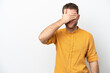 © luismolinero - Young caucasian man isolated on white background covering eyes by hands. Do not want to see something