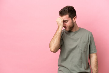 Poster - Young caucasian man isolated on pink background with headache