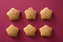 Six Star Shaped Cookies In Two Rows On A Festive Red Background For Celebrating Christmas And New Year