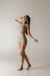© master1305 - Slim sportive young woman in underwear on grey background. Fitness, diet, skin and body care.