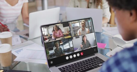 Sticker - African american man using laptop for video call, with diverse business colleagues on screen