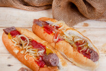 South African Famous Boerewors Roll, Juicy And Topped With Onions On A Rustic Surface