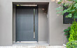 Contemporary house entrance metallic grey door. Tranquil Athens suburbs, Greece.