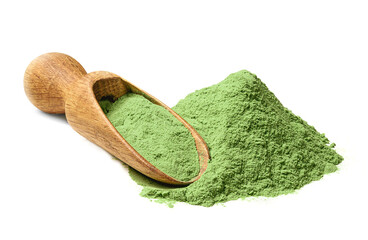 Heap of Barley grass green powder with wodden shovel, detox superfood