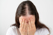 Close up of hair loss woman stressed and crying over rapid hair loss against white background