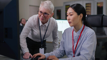 diverse colleagues discuss data on computer working in modern office