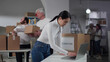 © TommyStockProject - Charity organization manager work on laptop in warehouse