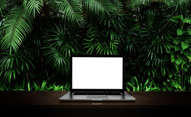 Wall Mural - Modern laptop  isolated on green leaf background. 3D illustration.
