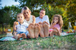 Close-up of the soles of the feet of a family during a picnic in a park