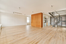 Empty Large Room With White Walls And Wooden Flooring