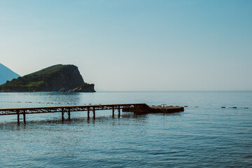 Amazing view of St.Nicholas island and the sea near Budva. Beautiful cloudy sky. T