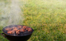 Barbecue Grill With Smoke On Nature, Outdoor. Barbecue Saturated Composition, Grilling Time, Close-up, Copy Space.