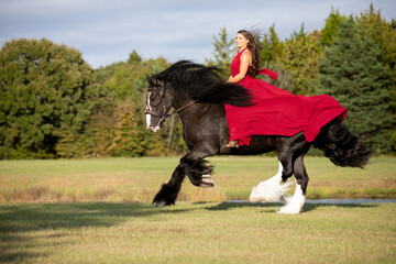 Woman in a red dress on a Horse