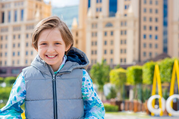 Wall Mural - portrait of a happy boy walking in the park on Paveletskaya Square in the city of Moscow