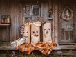 Photo zone for Halloween with festive handmade paraphernalia. Kraft paper bags painted with Jack pumpkin grimace, monsters decorations for Halloween