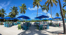 A Typical Beach Restaurant With Colorful Tables, Chairs And Umbrellas In The Florida Keys.