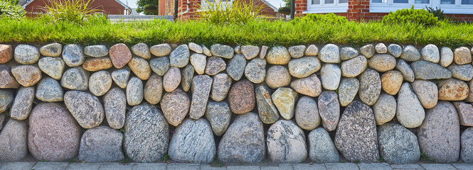 Poster - Rustic garden wall with wackerstones, in panoramic format.