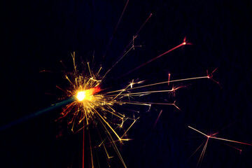 Wall Mural - a sparkler is a firework that glows and sparks