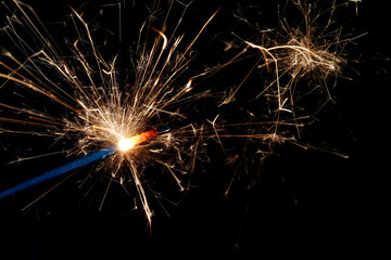 Wall Mural - a sparkler is a firework that glows and sparks