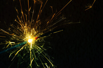 Wall Mural - a sparkler is a firework that glows and sparks