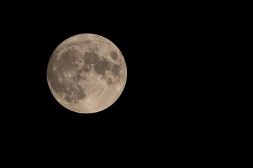 99% waxing gibbous illumination. nearly full moon in northern hemisphere during september. craters a