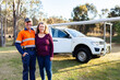 © Austockphoto - Happy middle aged Aussie couple infront of work ute for start up business